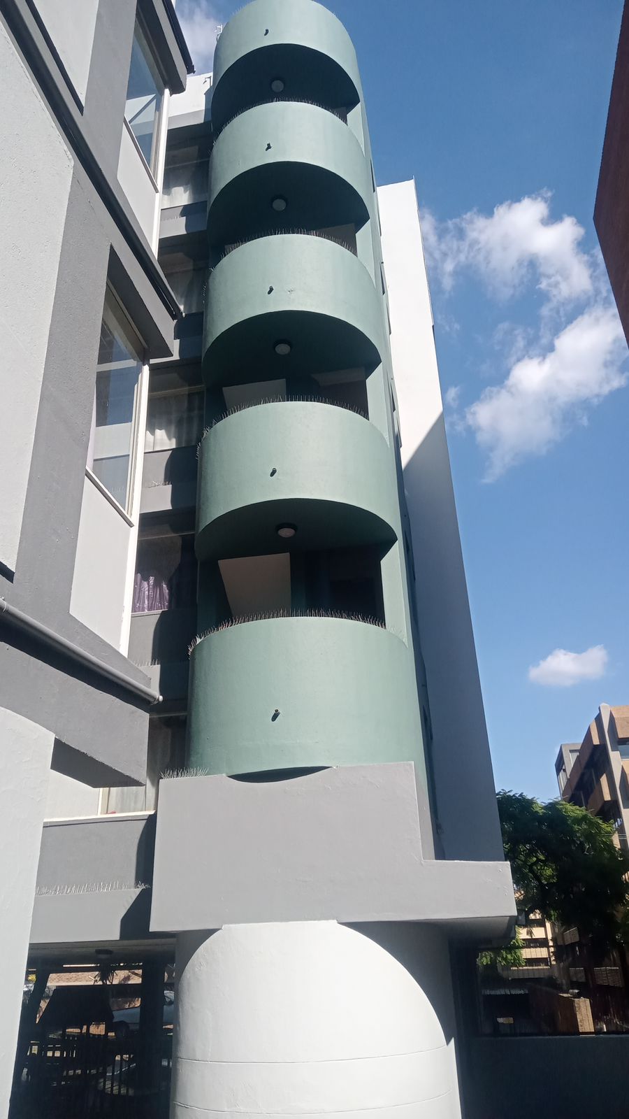 Rope access painters Johannesburg apartment cylindrical tower after painting completed