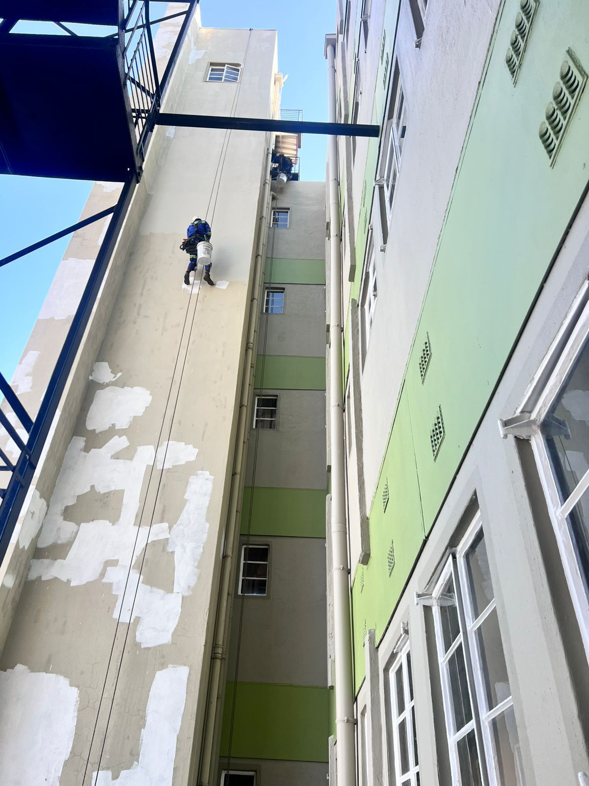Rope access abseiling painters Sandton narrow building shaft in progress